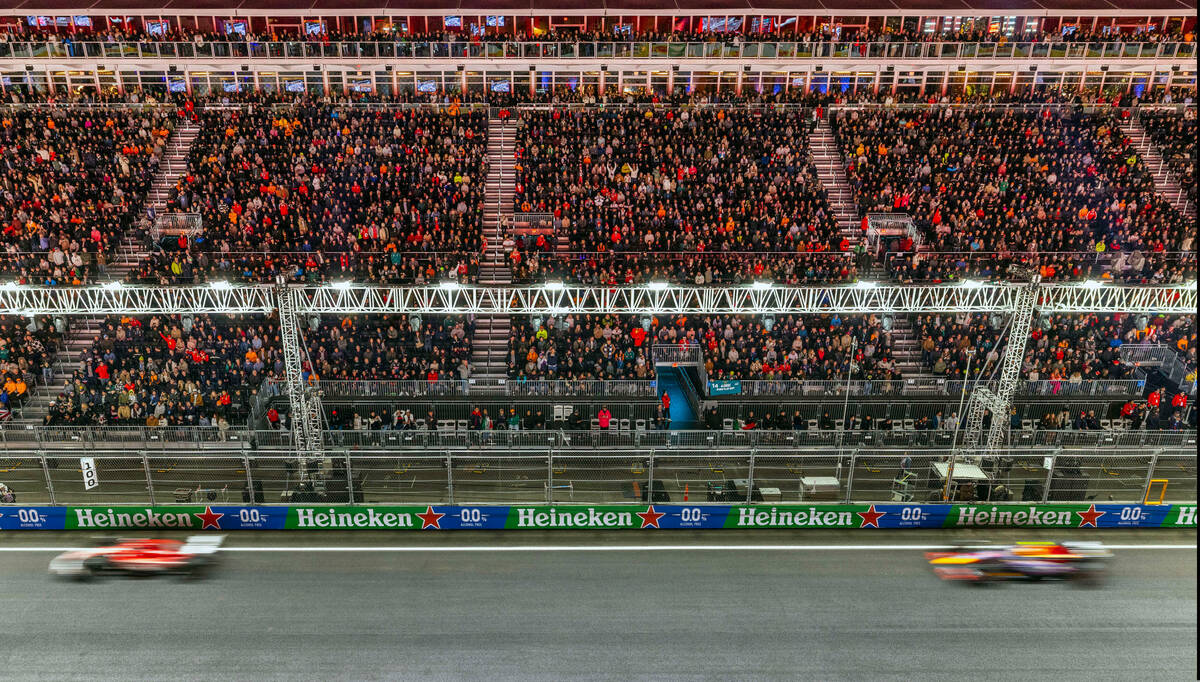 Ferrari driver Charles LeClerc leads Red Bull Racing driver Max Verstappen down the front strai ...