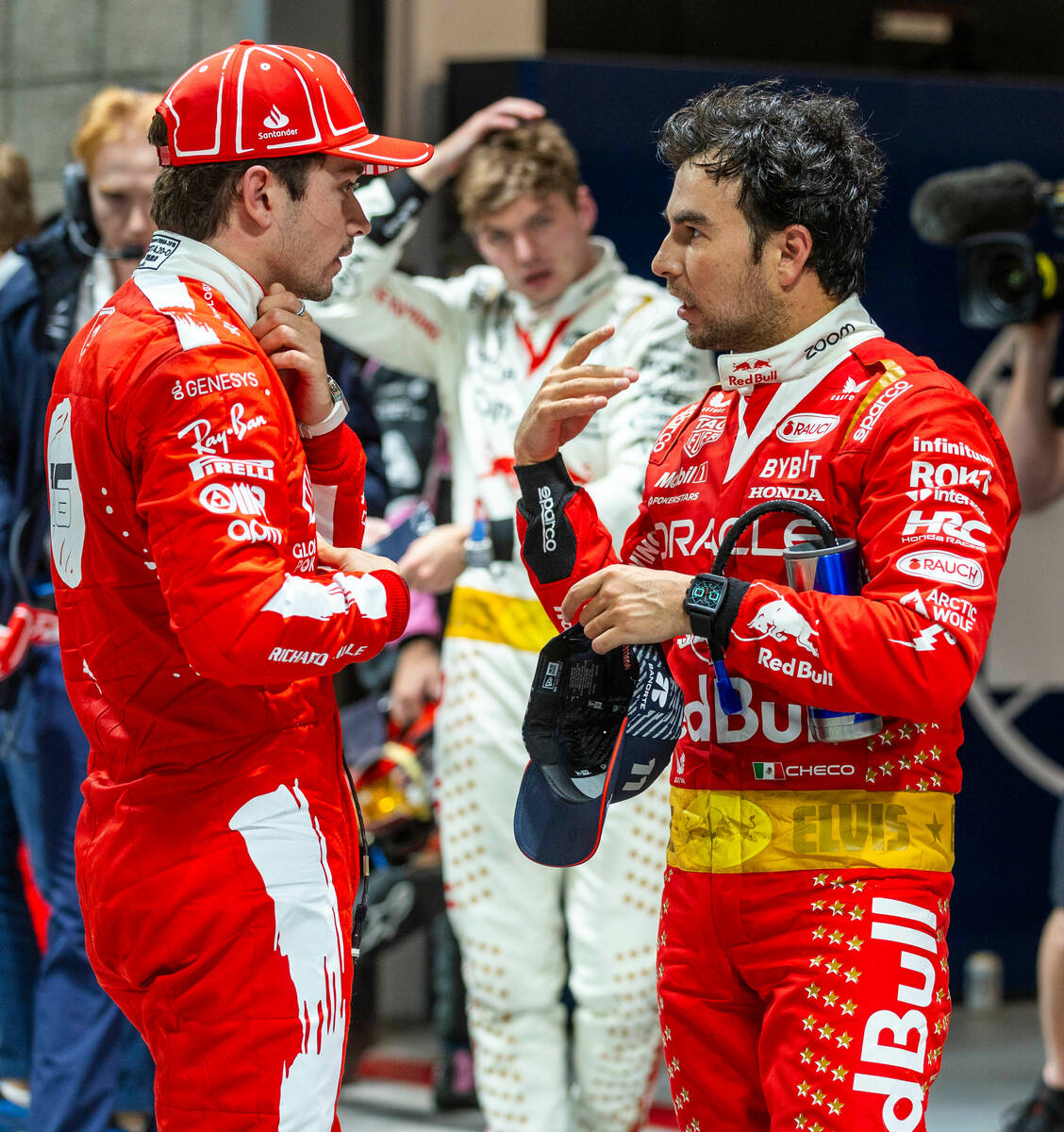 Ferrari driver Charles Leclerc, left, talks with Red Bull Racing driver Sergio Perez following ...