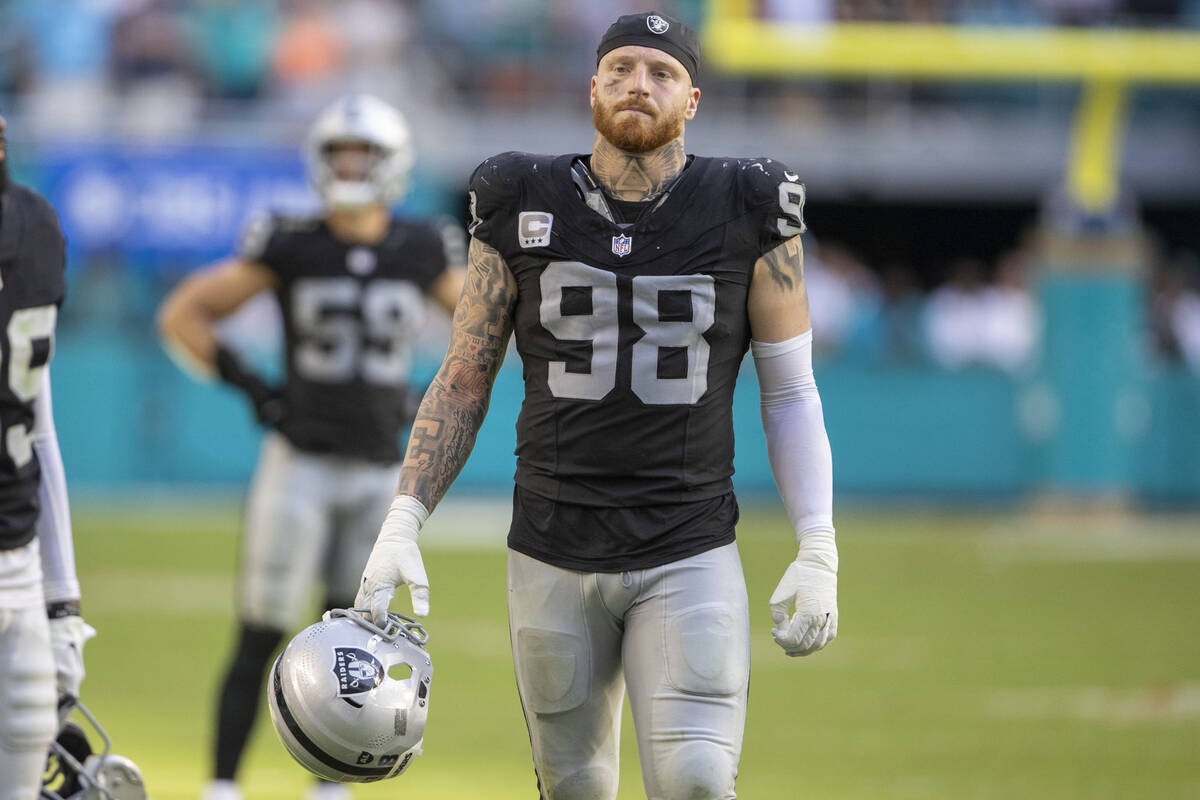 Raiders defensive end Maxx Crosby (98) reacts after Miami Dolphins cornerback Jalen Ramsey (5) ...