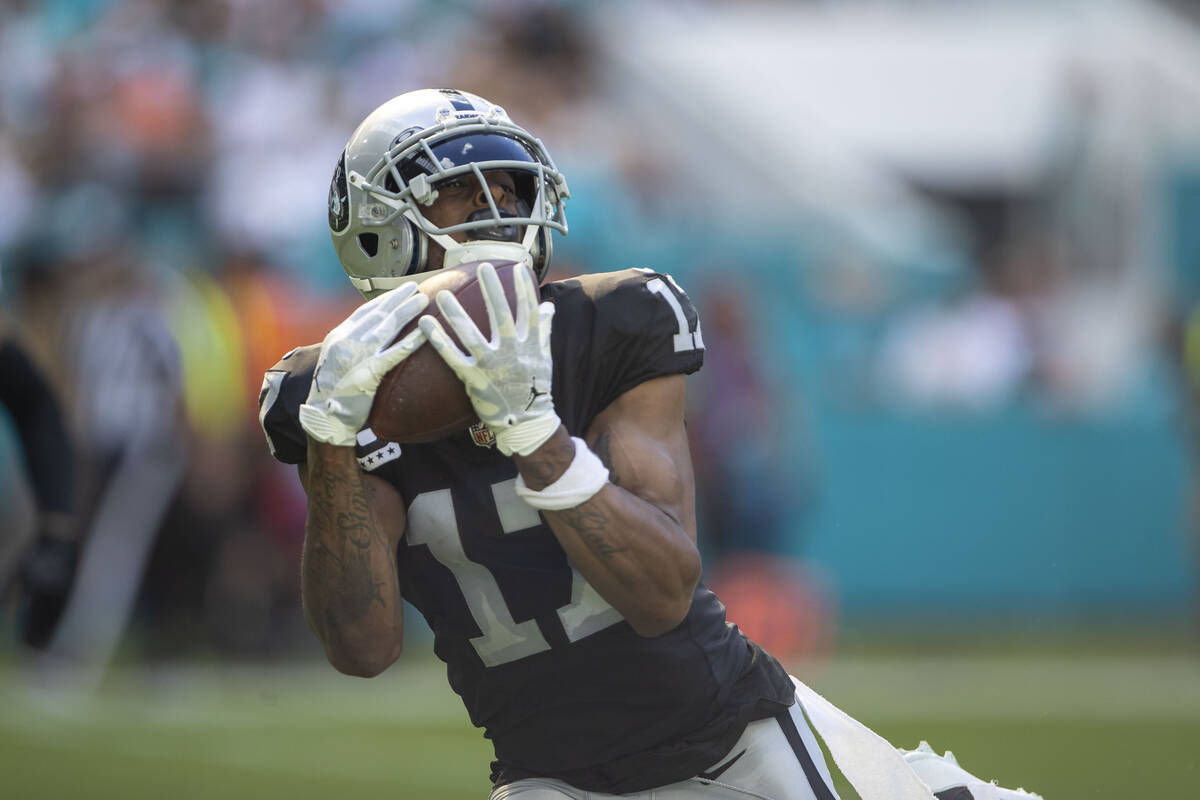 Raiders wide receiver Davante Adams (17) makes a catch and heads to the end zone during the fir ...