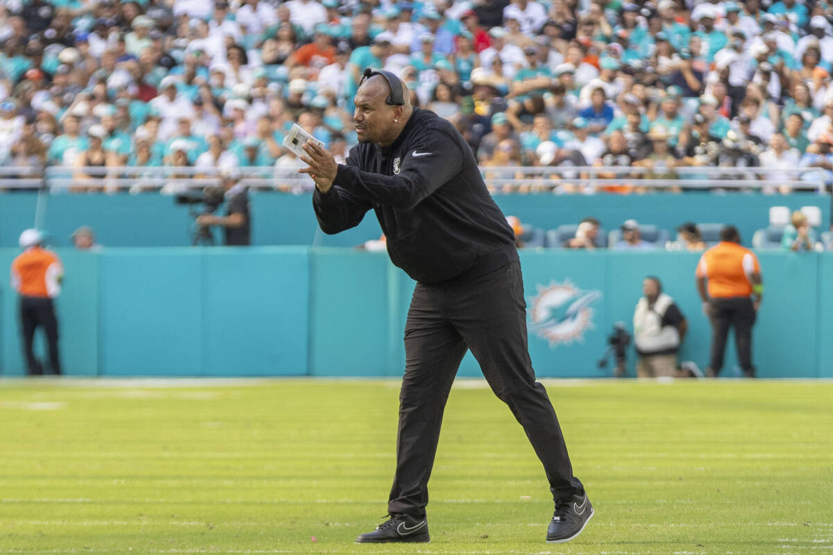 Raiders interim head coach Antonio Pierce applauds after an extra point is kicked during the fi ...