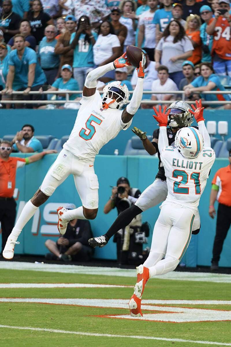 Miami Dolphins cornerback Jalen Ramsey (5) intercepts a pass in the end ozone intended for Las ...