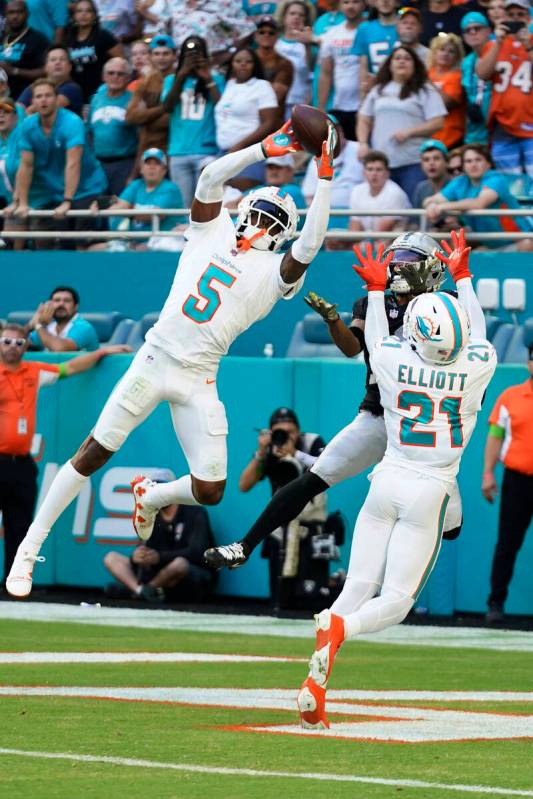 Miami Dolphins cornerback Jalen Ramsey (5) intercepts a pass in the end ozone intended for Las ...