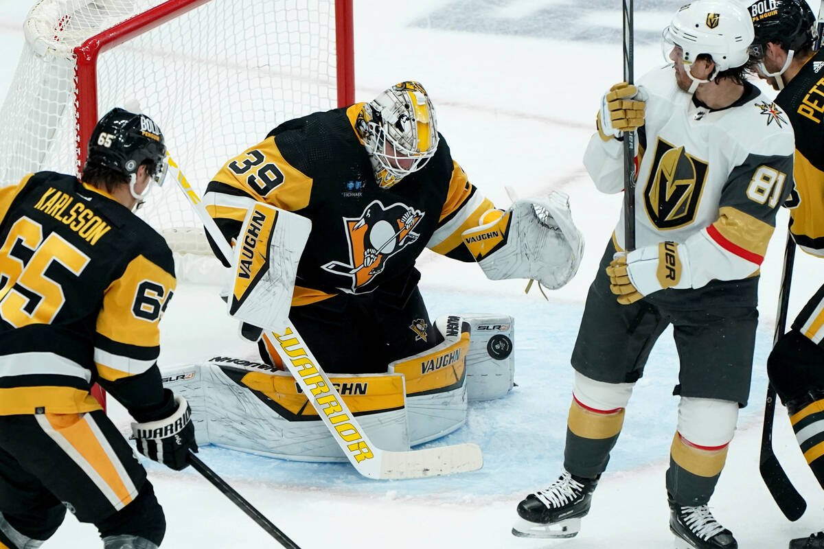 Pittsburgh Penguins goaltender Alex Nedeljkovic reaches to stop a puck in front of Vegas Golden ...