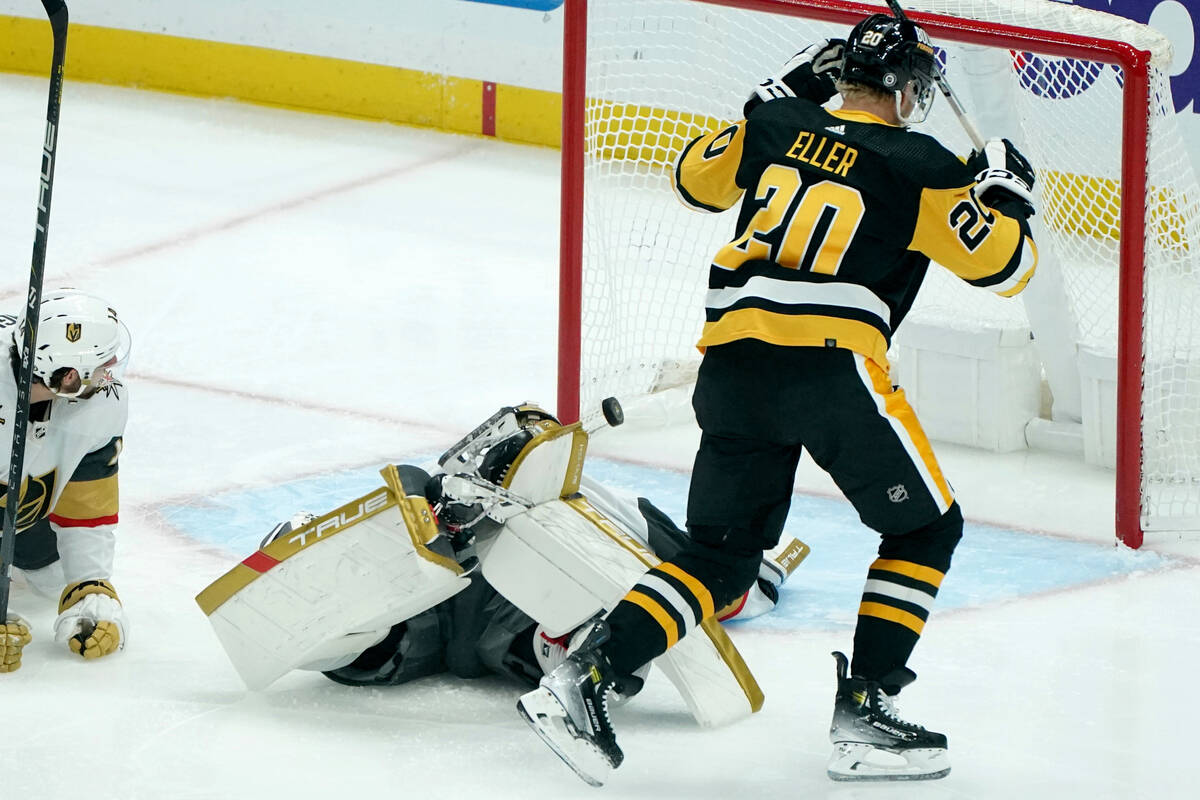Pittsburgh Penguins' Lars Eller (20) watches a shot by Penguins' Ryan Graves get by Vegas Golde ...