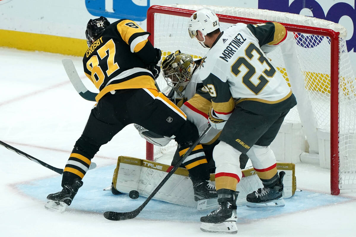 Vegas Golden Knights goaltender Adin Hill blocks a shot in front of Pittsburgh Penguins' Sidney ...
