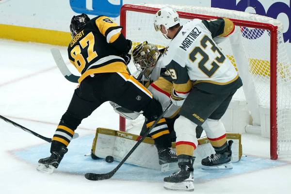 Vegas Golden Knights goaltender Adin Hill blocks a shot in front of Pittsburgh Penguins' Sidney ...