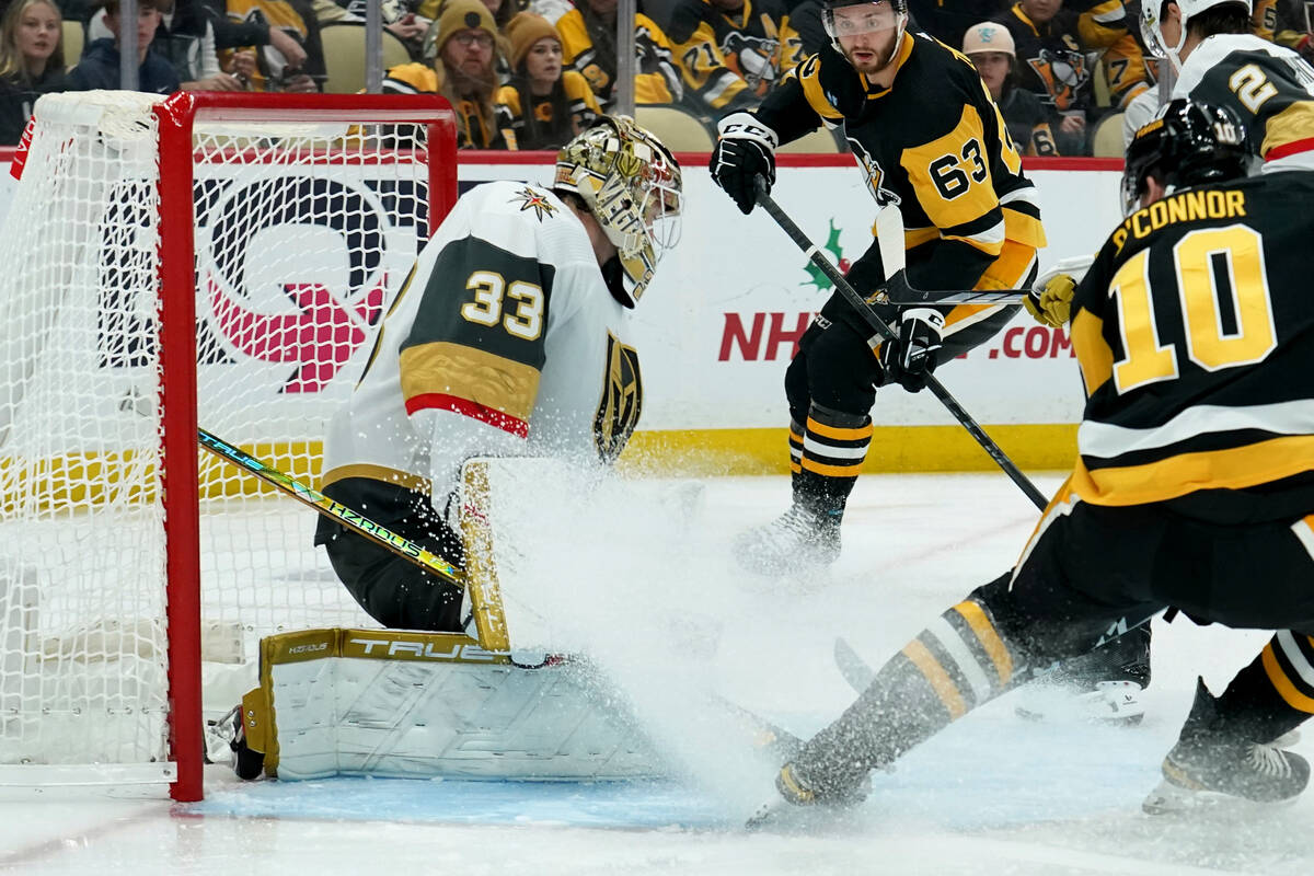 Vegas Golden Knights goaltender Adin Hill (33) makes a save on Pittsburgh Penguins' Drew O'Conn ...
