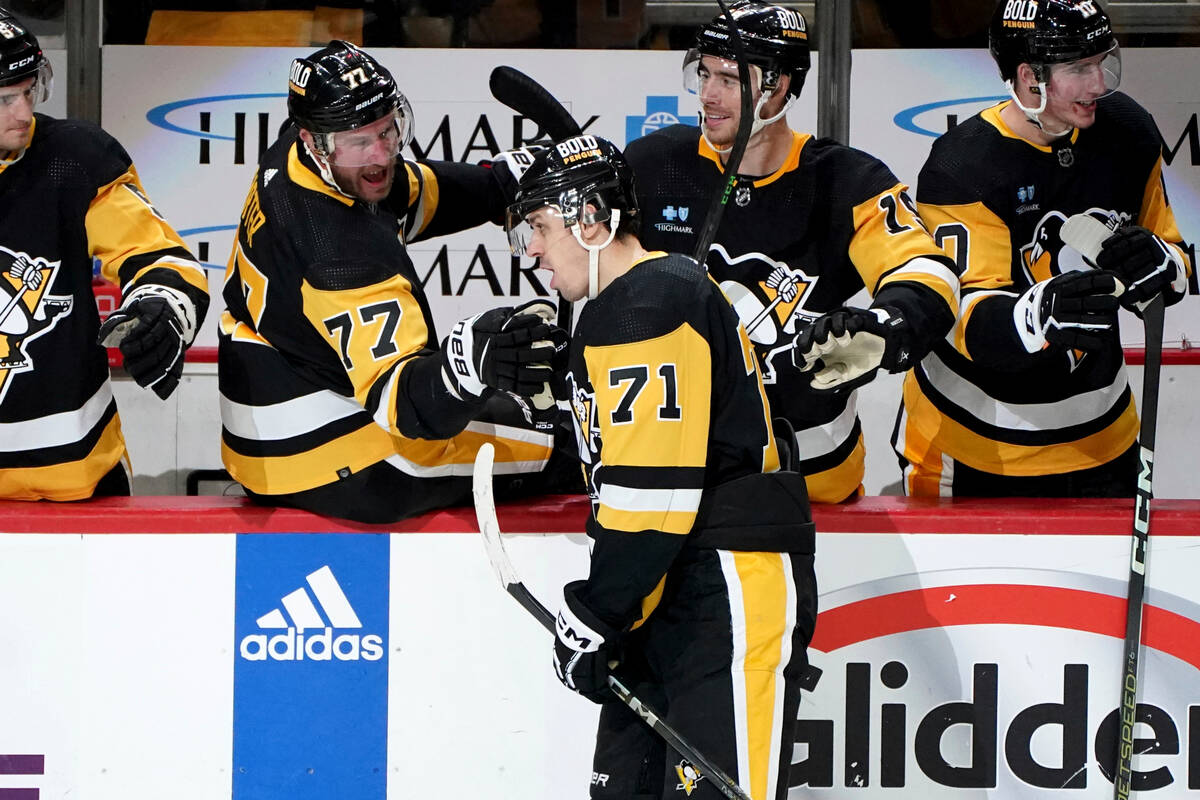 Pittsburgh Penguins' Evgeni Malkin (71) returns to the bench after scoring an empty-net goal ag ...