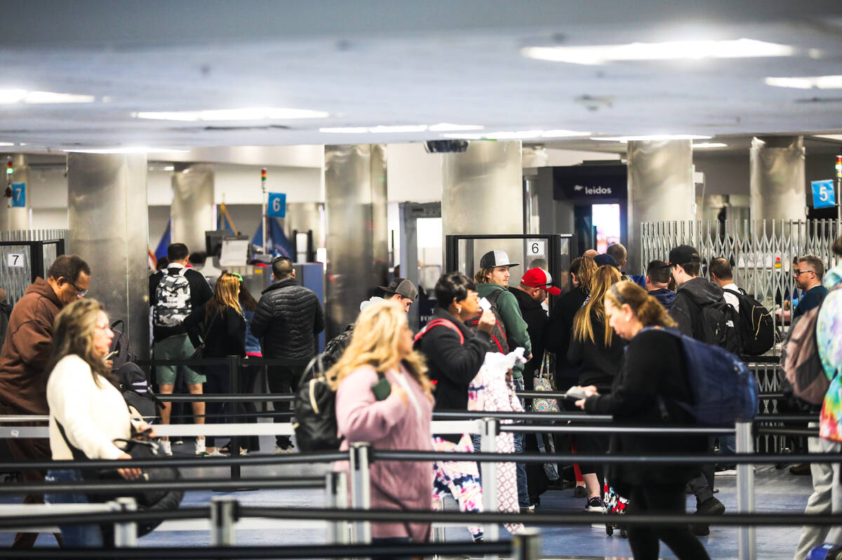 Guests wait through security lines at Harry Reid International Airport in Las Vegas, Sunday, No ...