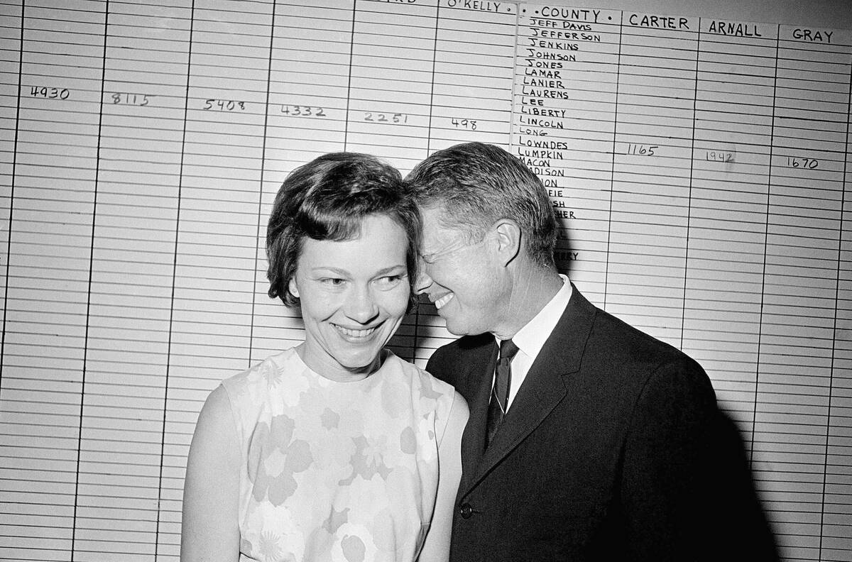 In this Sept. 15, 1966, file photo, then Georgia State Sen. Jimmy Carter hugs his wife, Rosalyn ...