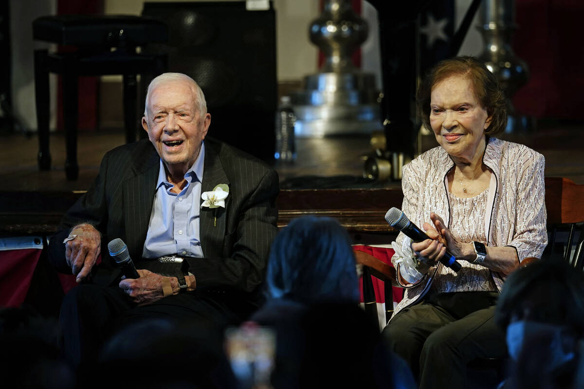 Former President Jimmy Carter and his wife former first lady Rosalynn Carter sit together durin ...