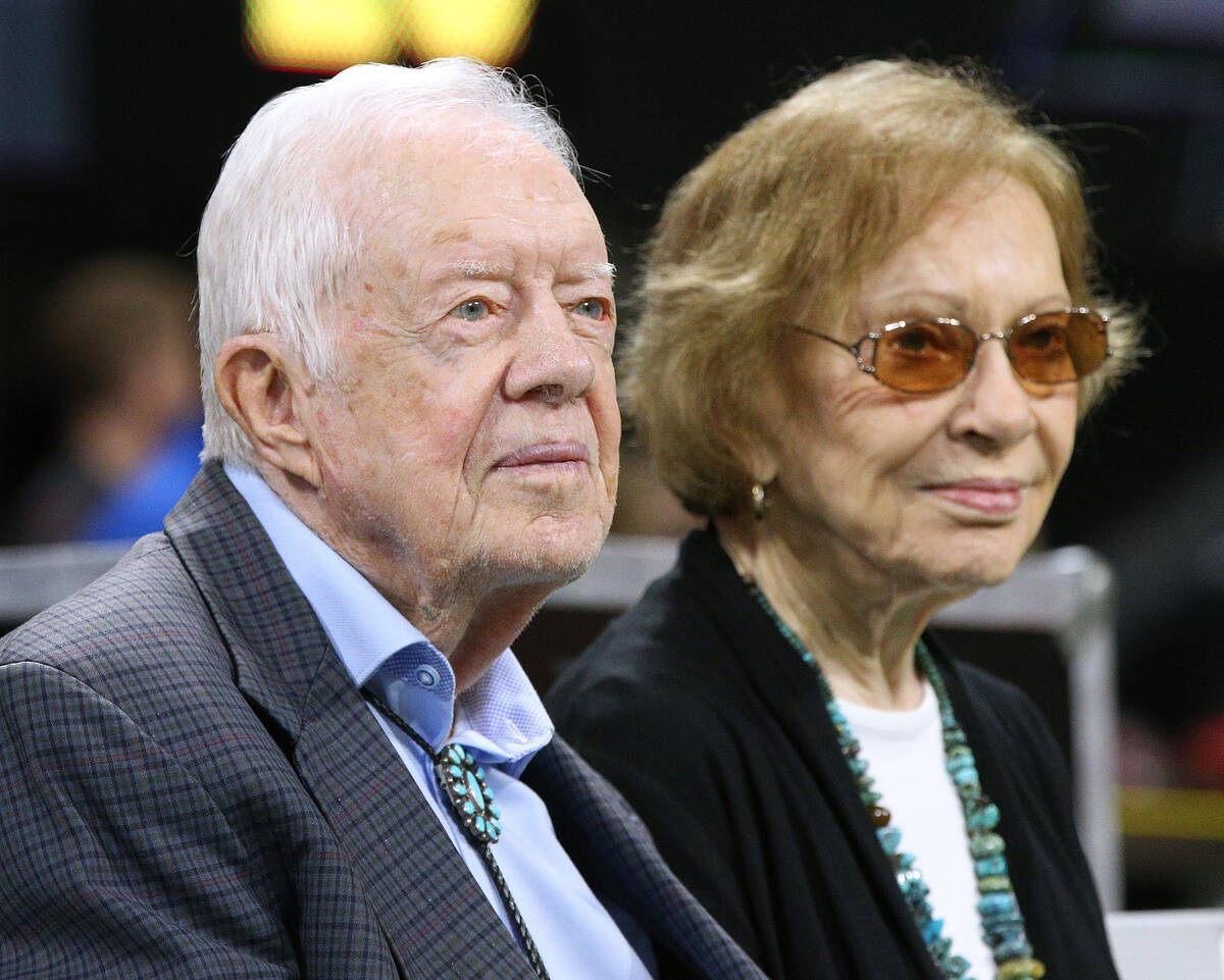 Former President Jimmy Carter, left, and first lady Rosalynn Carter look on during an NFL game ...