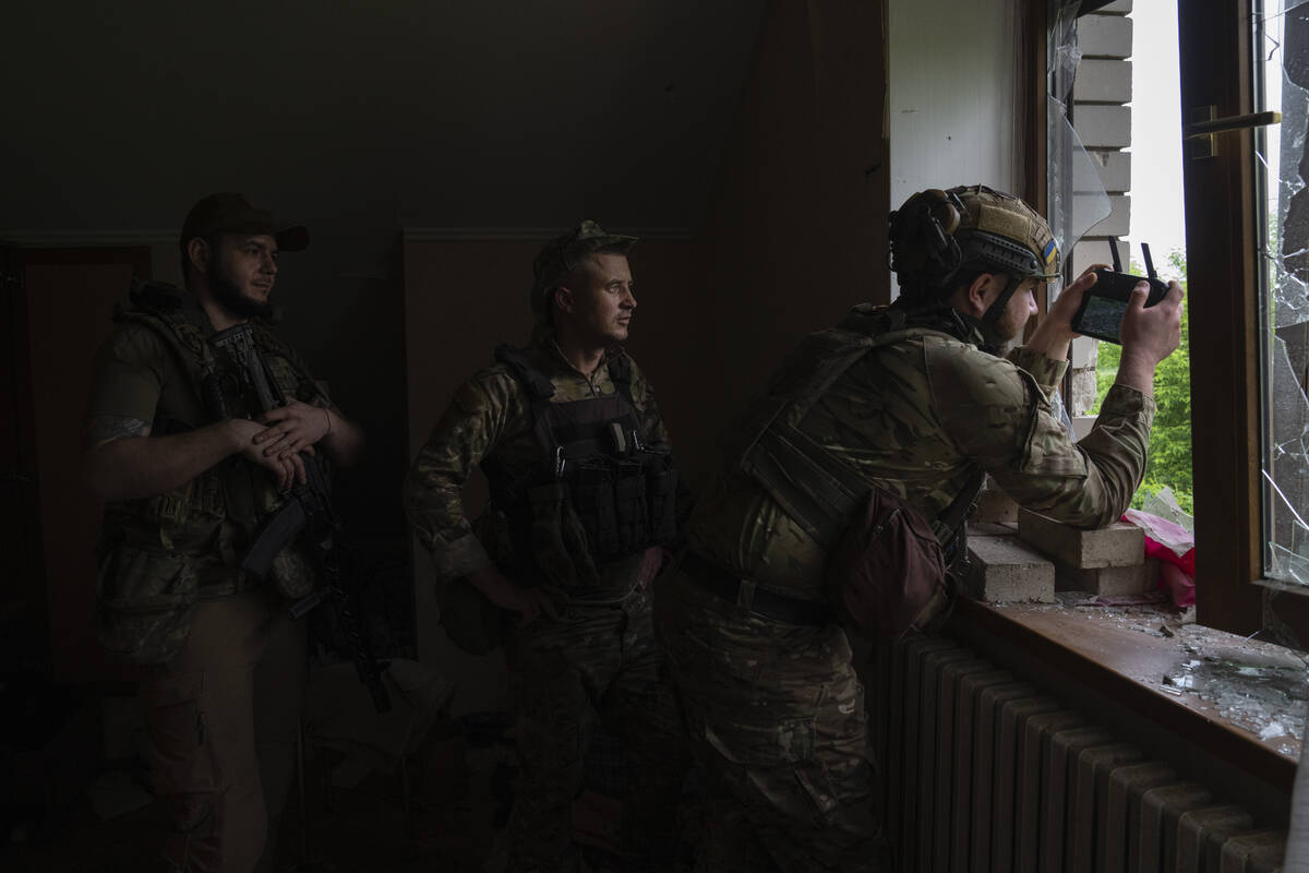 An officer of Ukraine's 59th Motorized Brigade controls a drone from a shelter in the suburbs o ...