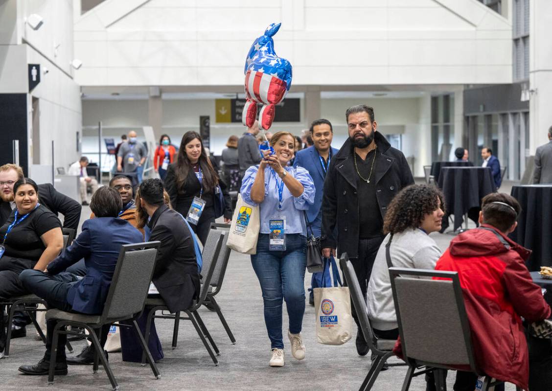 Delegate Margarita Darrett-Quiroz walks with a donkey balloon through the SAFE Credit Union Con ...