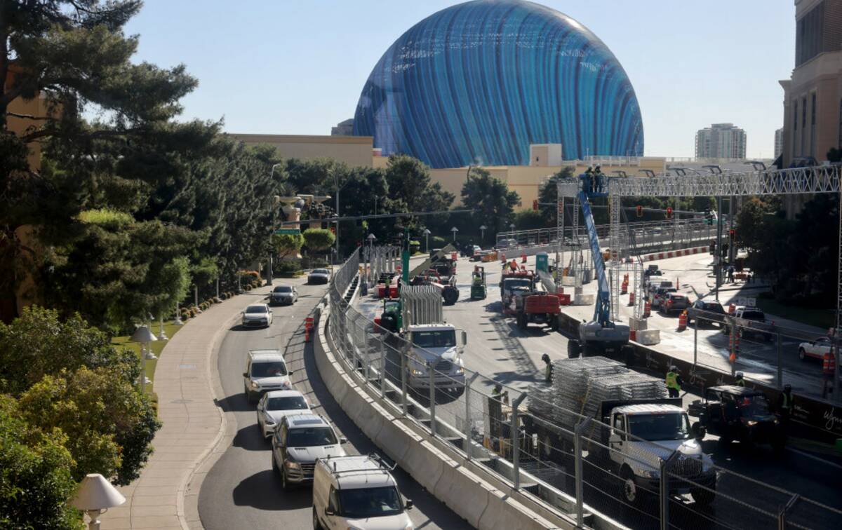 Crews removed fencing from the Formula One race course as one lane of traffic crawls by on Sand ...