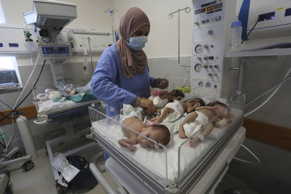 A nurse cares for prematurely born Palestinian babies that were brought from Shifa Hospital in ...