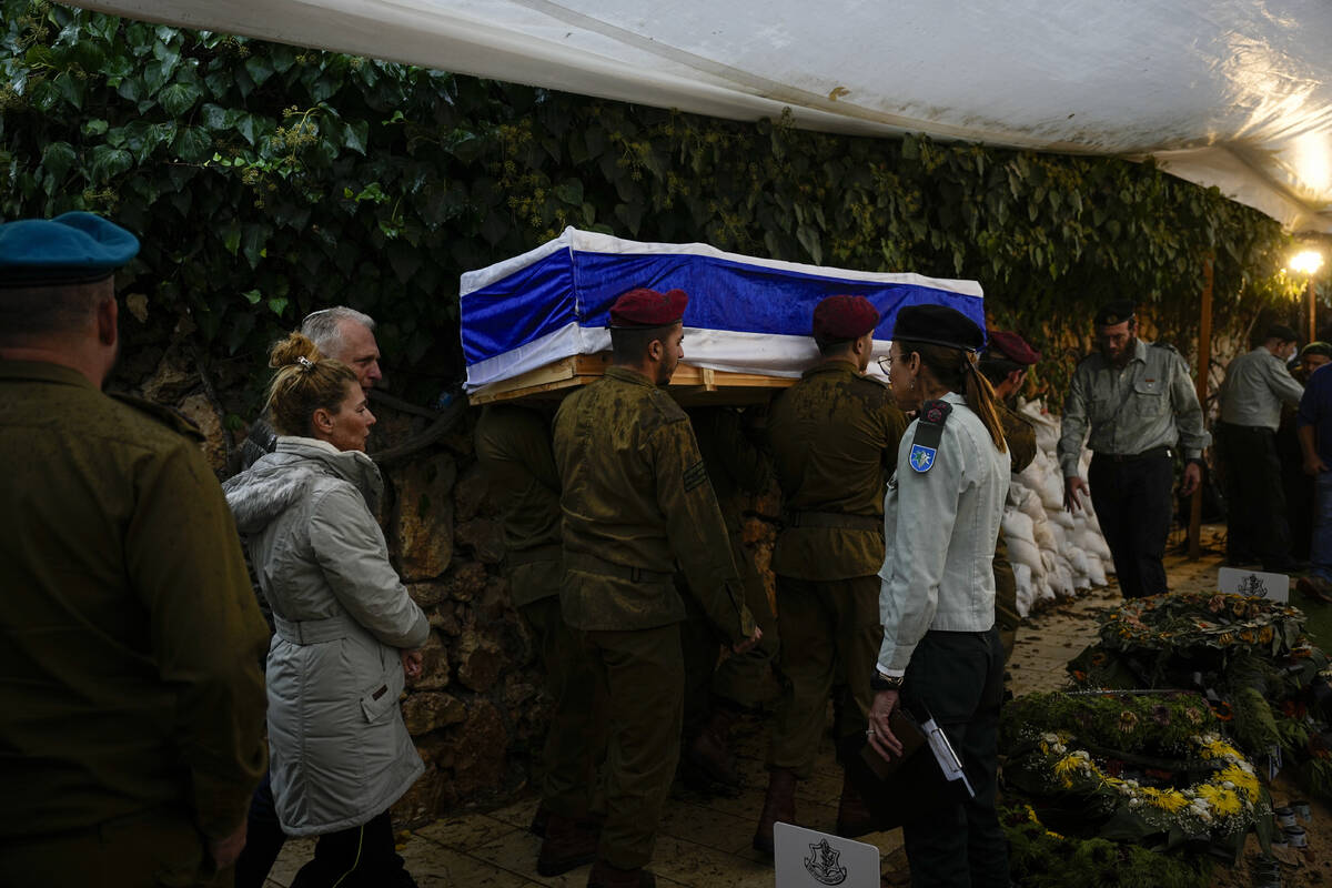 Israeli soldiers carry the flag-draped casket of Staff Sergeant Shachar Fridman, during his fun ...