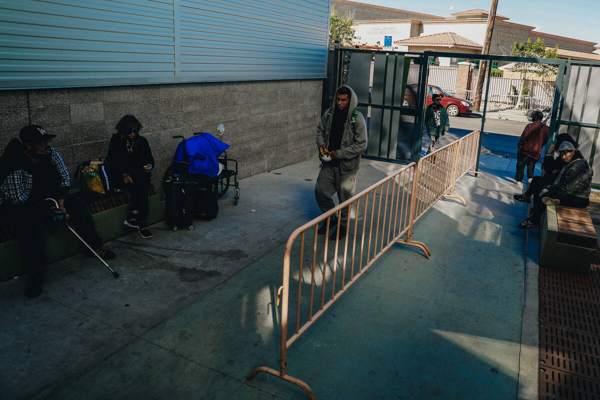 People are seen sitting outside the Courtyard Homeless Resource Center on Oct. 28, 2023, in Las ...