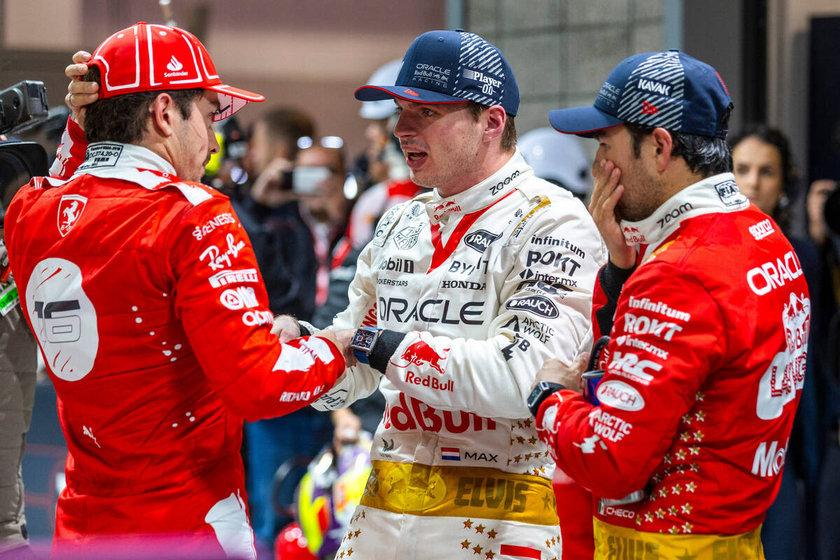 Ferrari driver Charles Leclerc, left, talks with Red Bull Racing driver Max Verstappen and team ...