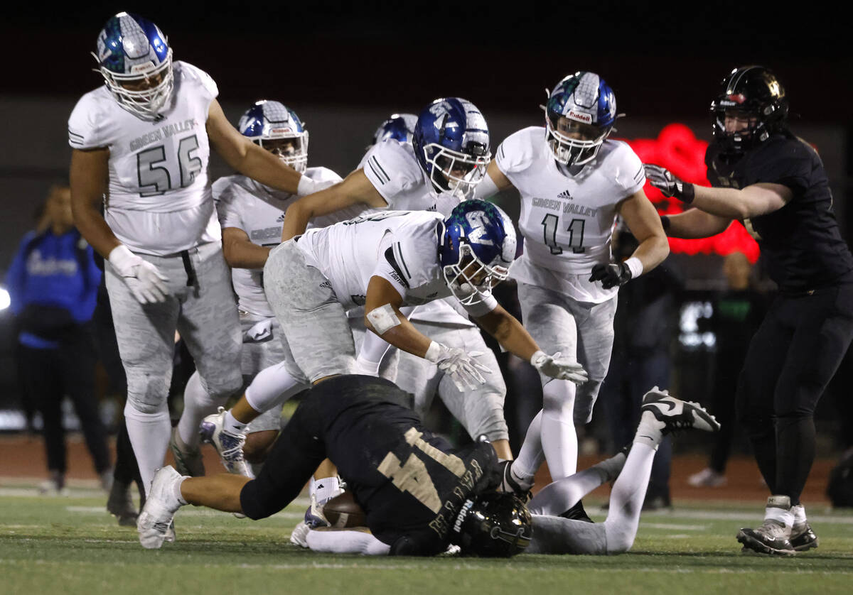 Faith Lutheran's running back Cale Breslin (14) is taken down by Green Valley defense during a ...