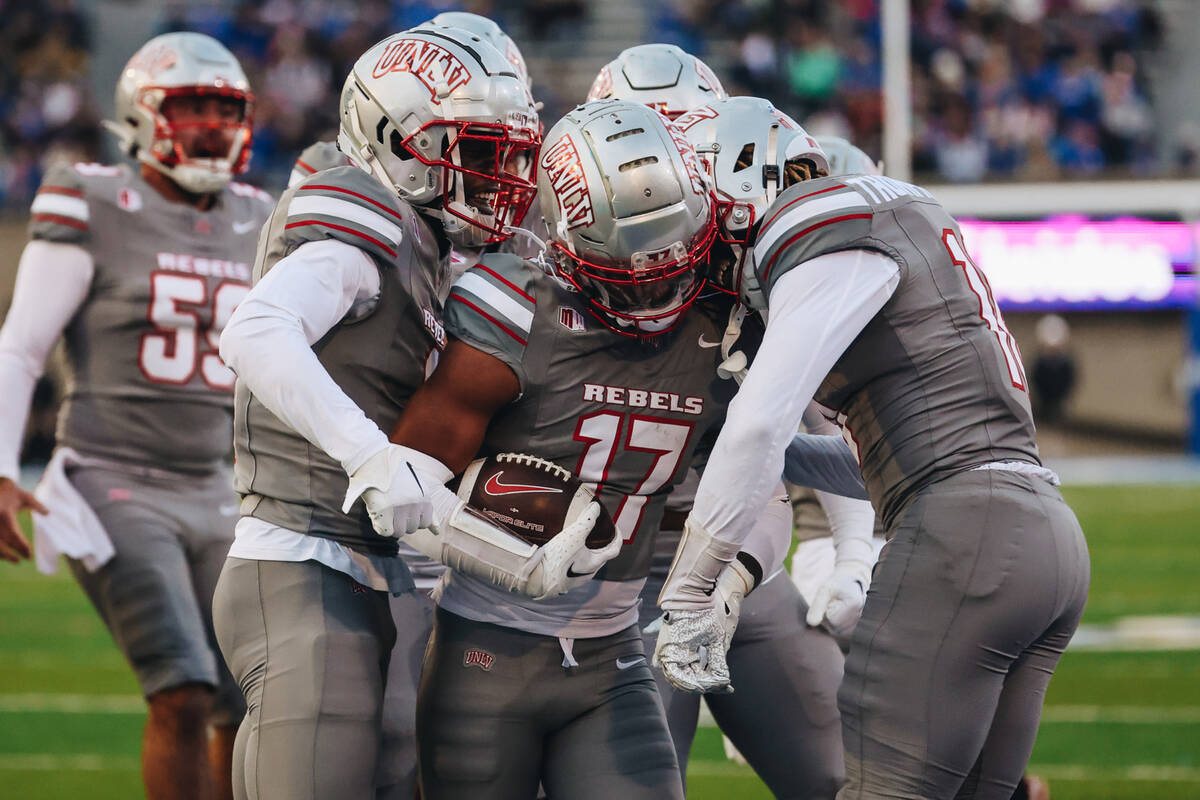 UNLV players celebrate defensive back Kris Williams (17) after a play during a game against Air ...