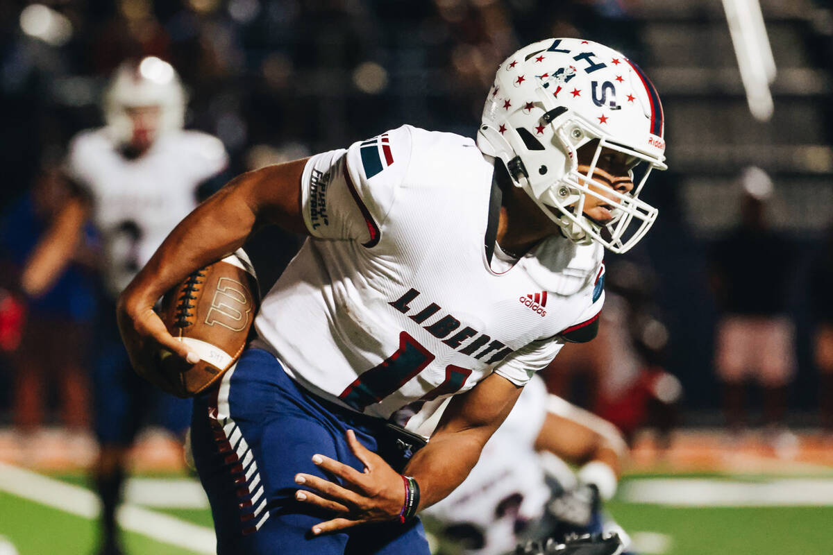 Liberty quarterback Tyrese Smith (11) runs the ball during a game against Bishop Gorman at Bish ...