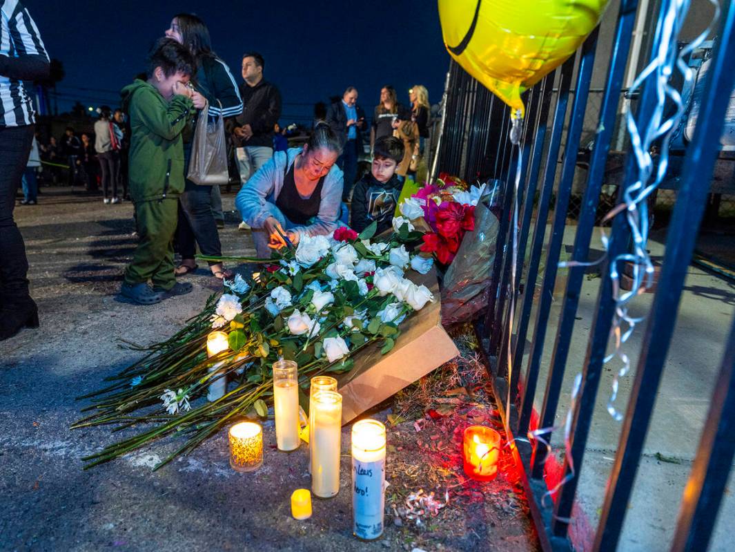 Candles are lit and flowers are laid at a makeshift memorial during a "Peace, Solidarity, ...