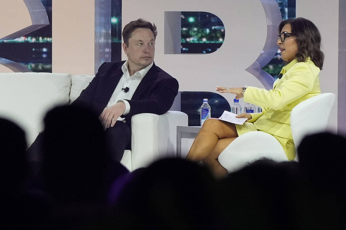 FILE - Elon Musk, left, speaks with Linda Yaccarino, chairman of global advertising and partner ...