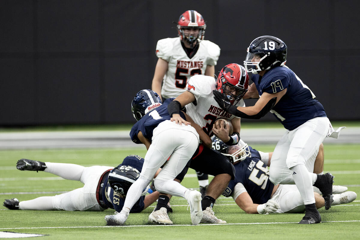 Pershing County’s Tyrn Sam (32) carries the ball while Lake Mead’s Andrew Pascua ...