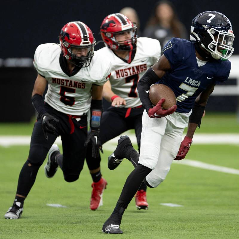 Lake Mead’s Jeremiah Turner (7) runs the ball followed by Pershing County’s Luis ...