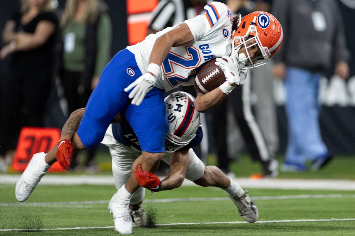 Bishop Gorman running back Micah Kaapana (22) is taken down on the carry by Liberty’s Ja ...