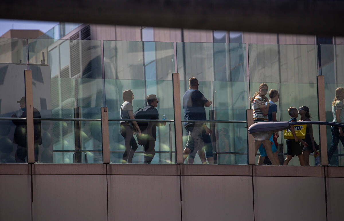 Pedestrians cross a bridge along the Las Vegas Strip on Wednesday, April 6, 2022, in Las Vegas. ...