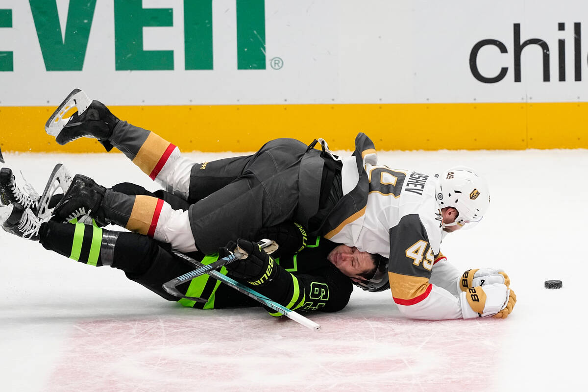 Vegas Golden Knights center Ivan Barbashev, top, falls on Dallas Stars right wing Evgenii Dadon ...