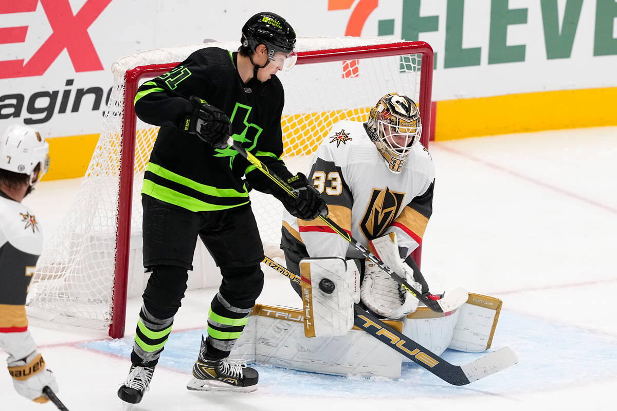 Vegas Golden Knights goaltender Adin Hill (33) makes a save as Dallas Stars left wing Jason Rob ...