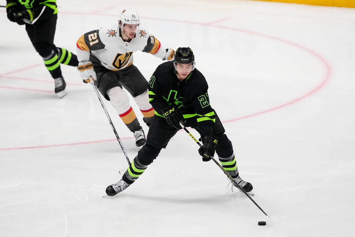 Dallas Stars left wing Jason Robertson, bottom, skates with the puck against Vegas Golden Knigh ...