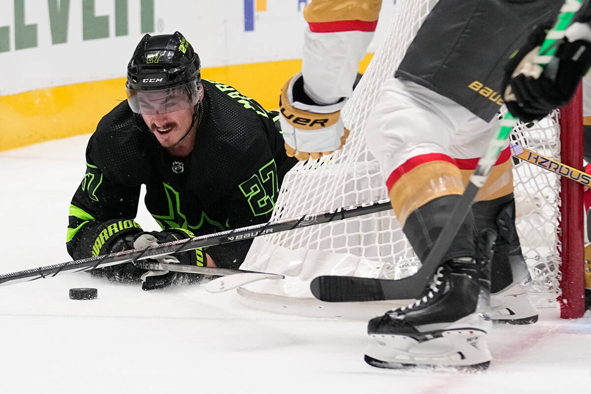 Dallas Stars left wing Mason Marchment tries to reach the puck after being knocked down during ...