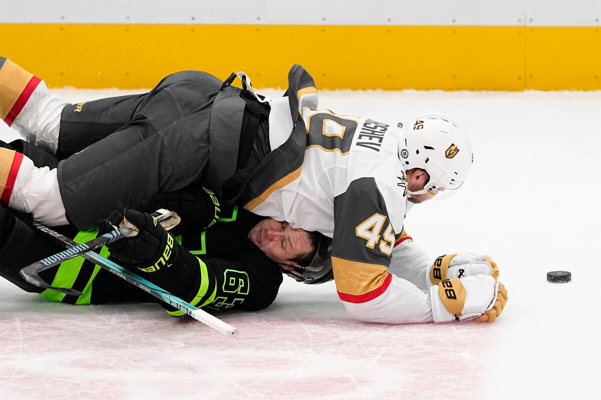 Vegas Golden Knights center Ivan Barbashev, top, falls on Dallas Stars right wing Evgenii Dadon ...