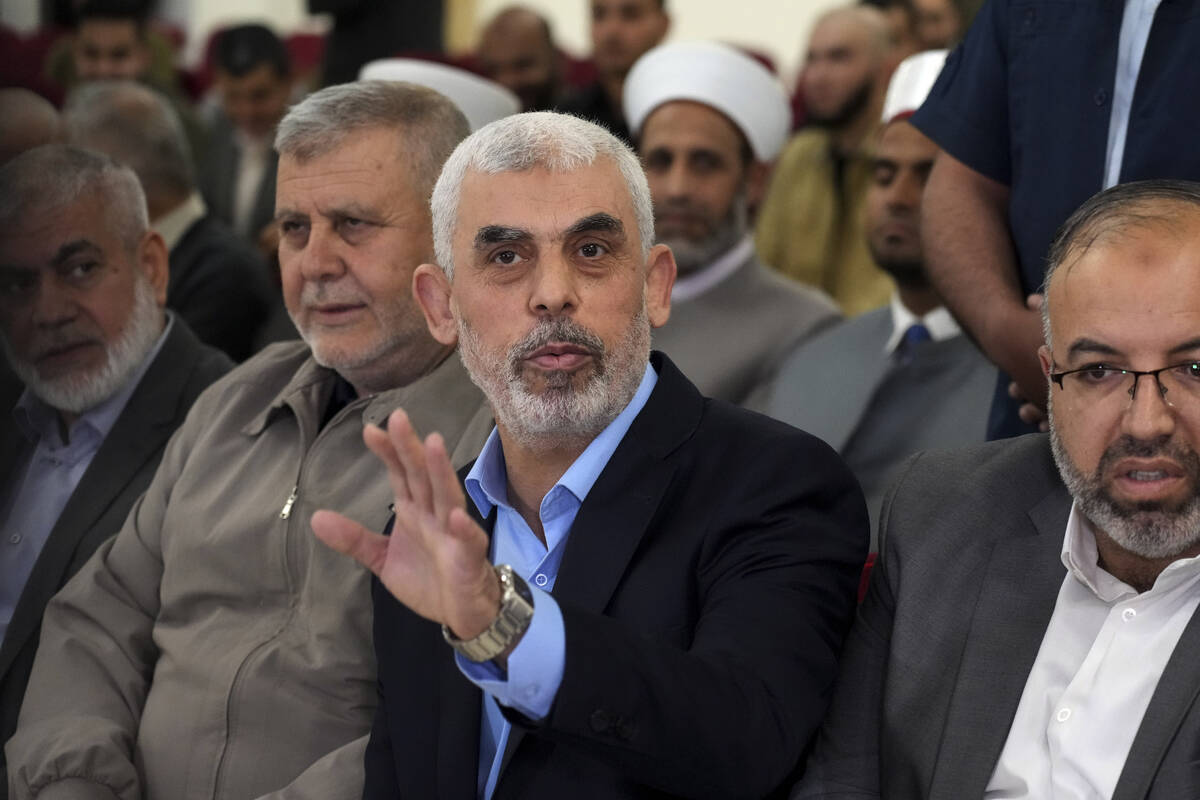 FILE - Yahya Sinwar, head of Hamas in Gaza, greets his supporters upon his arrival at a meeting ...