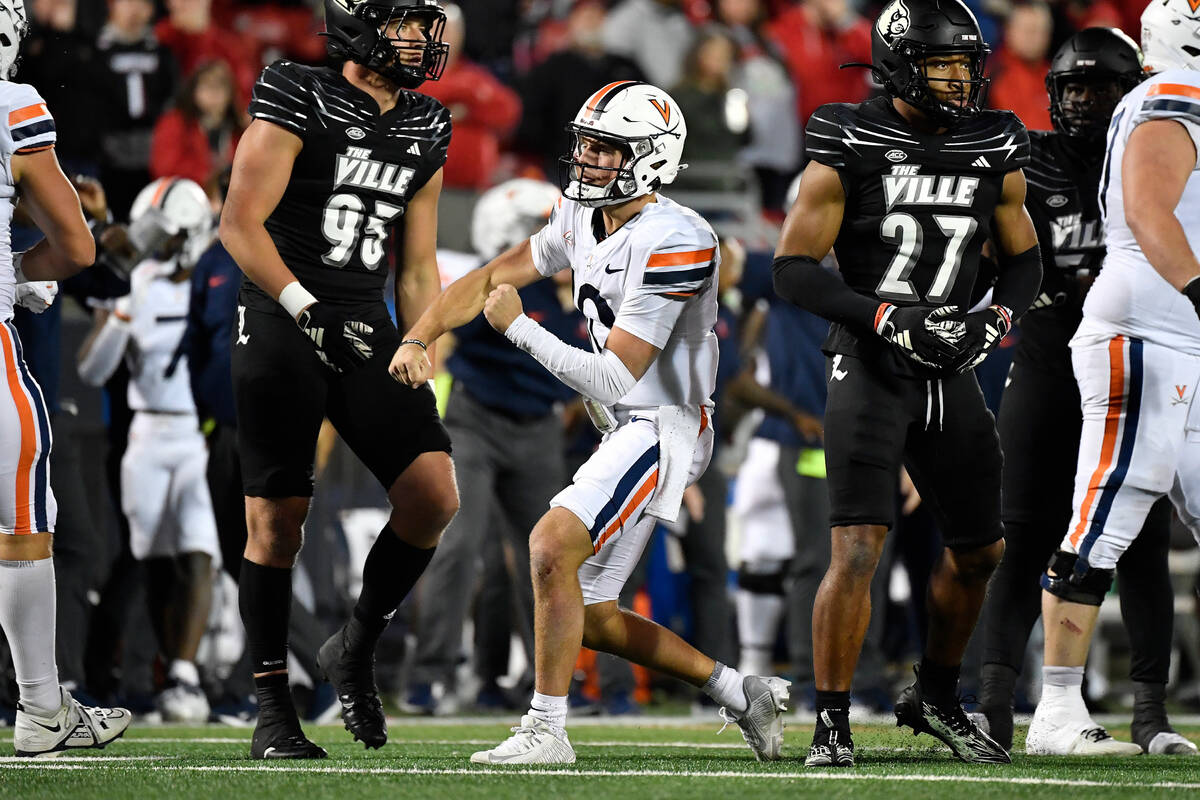 Virginia quarterback Anthony Colandrea, center, gestures after running for a first down during ...