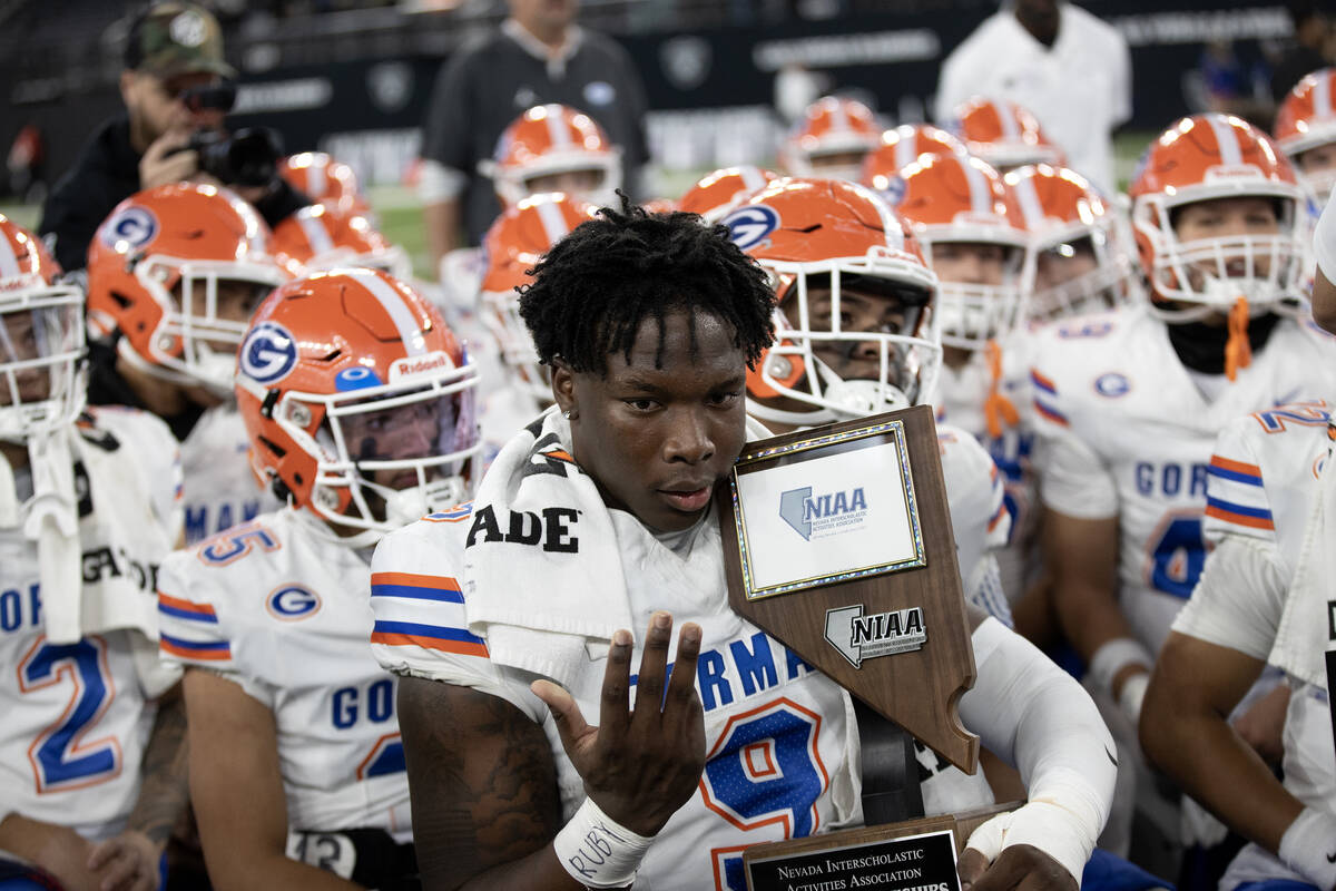 Bishop Gorman captain Elija Lofton celebrates with his team’s Class 5A Division I high s ...