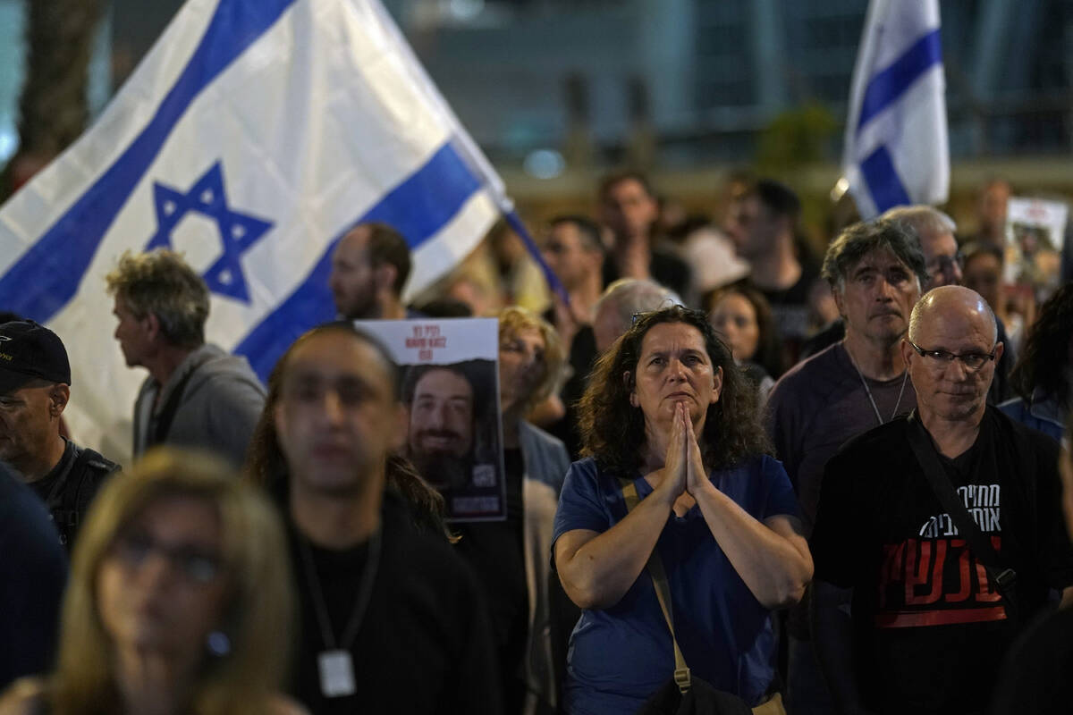 People participate in a show of solidarity with hostages being held in the Gaza Strip, near the ...