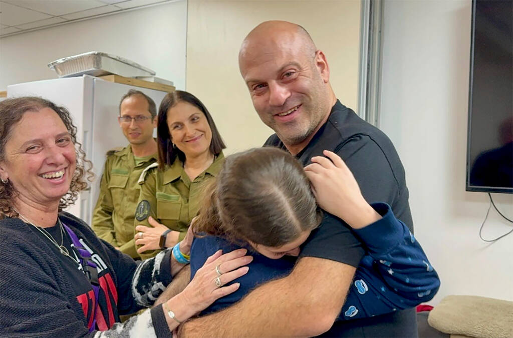 In this photo provided by the Israeli Army, Hila Rotem Shoshani, a released hostage, reunites w ...