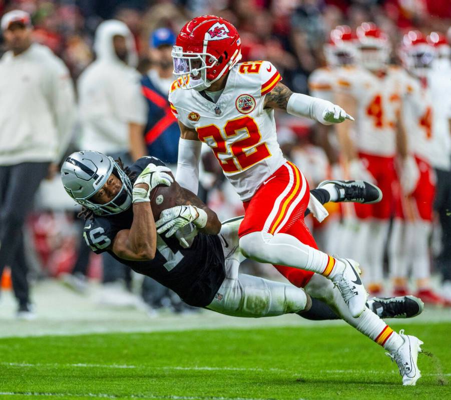 Raiders wide receiver Jakobi Meyers (16) hangs on to a long reception under tight coverage by K ...