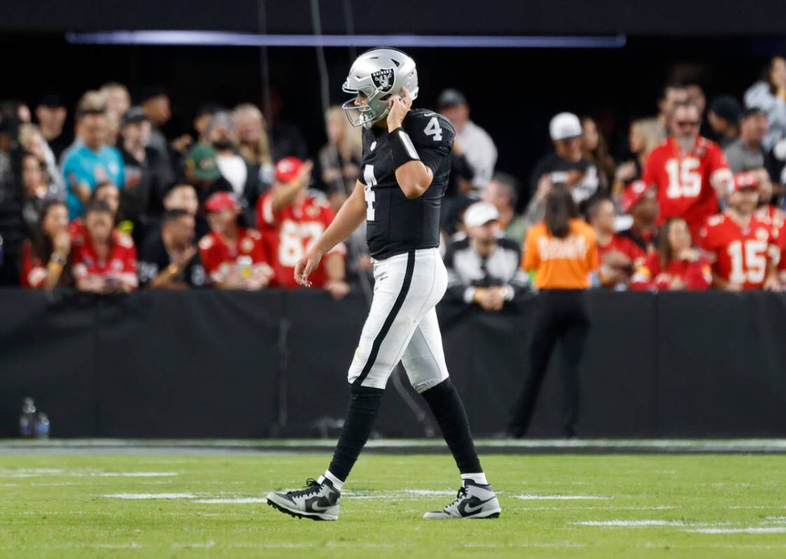 Raiders quarterback Aidan O'Connell (4) leaves the field after being sacked during the second h ...