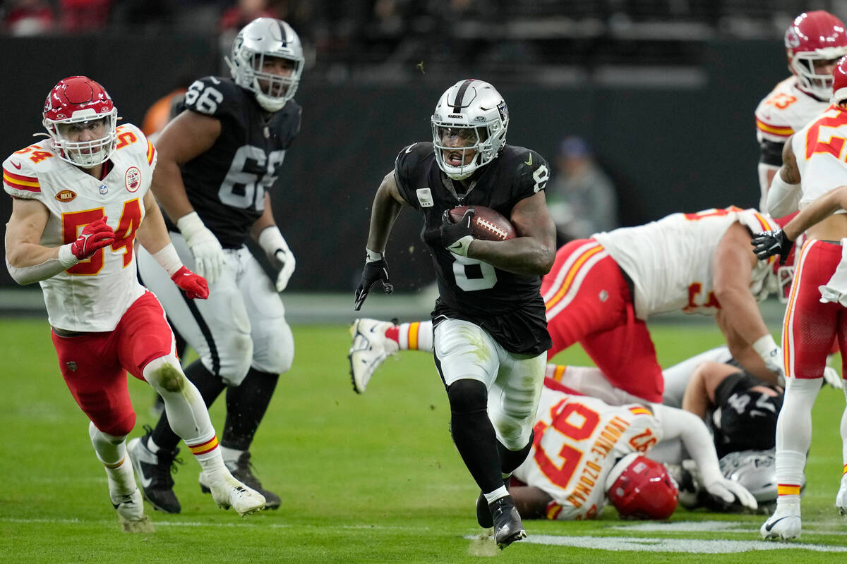 Las Vegas Raiders running back Josh Jacobs (8) runs past Kansas City Chiefs defenders to score ...