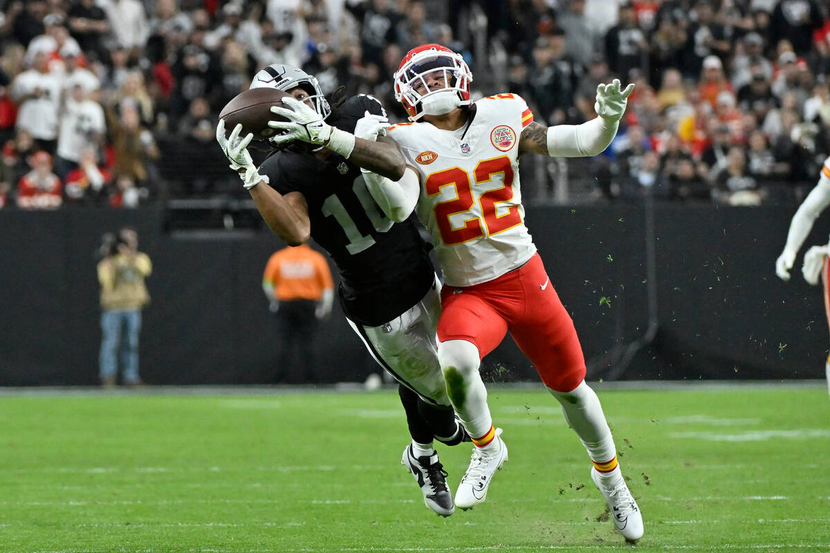 Las Vegas Raiders wide receiver Jakobi Meyers, left, catches a pass against Kansas City Chiefs ...