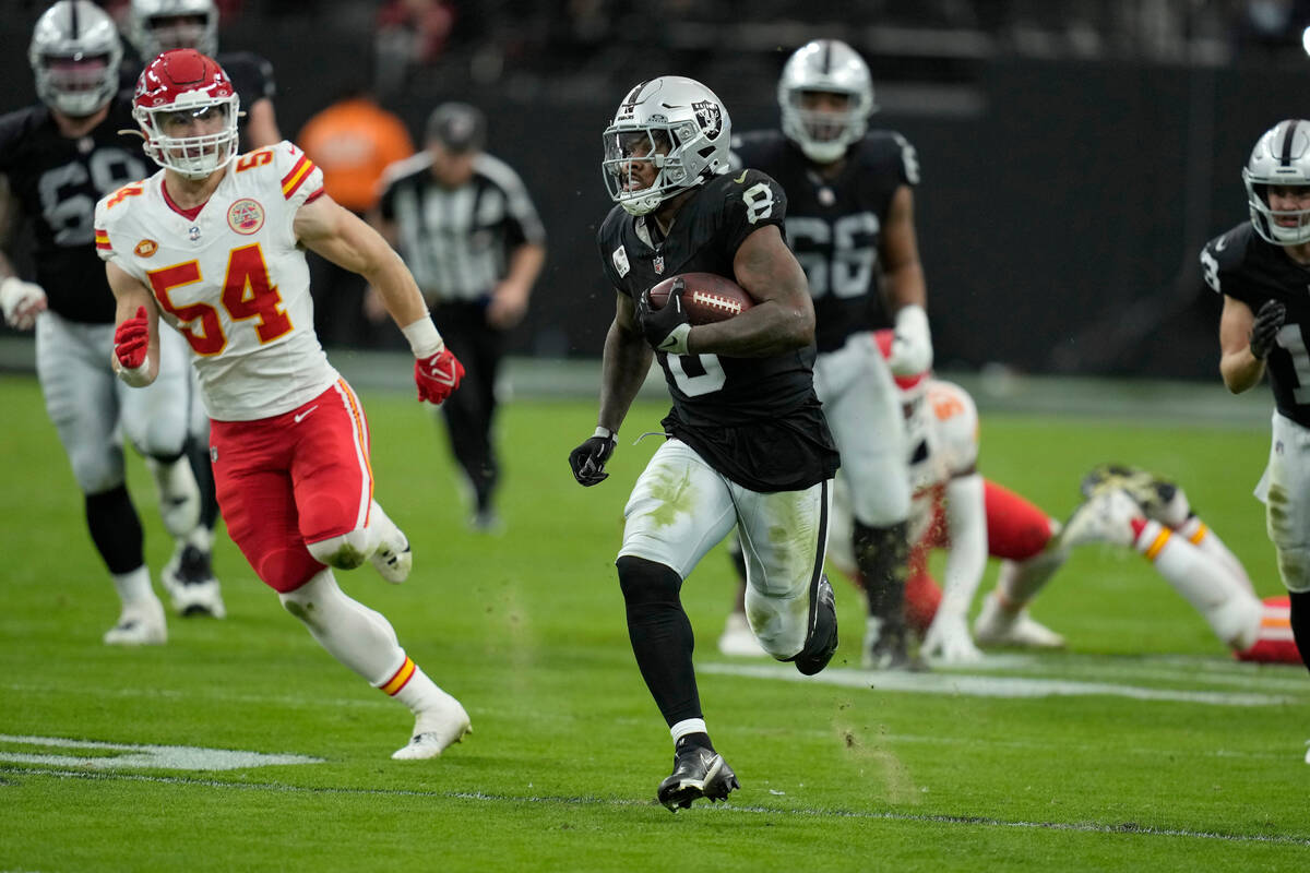 Las Vegas Raiders running back Josh Jacobs (8) runs past Kansas City Chiefs defenders to score ...