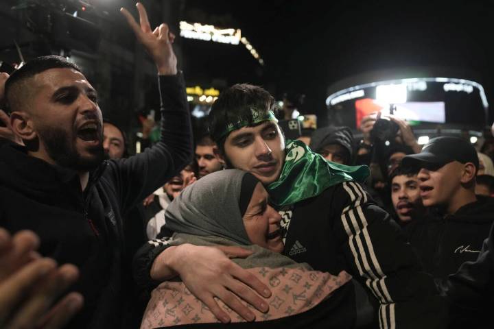 Omar Atshan, 17, is hugged by his mother after being released from an Israeli prison in the Wes ...