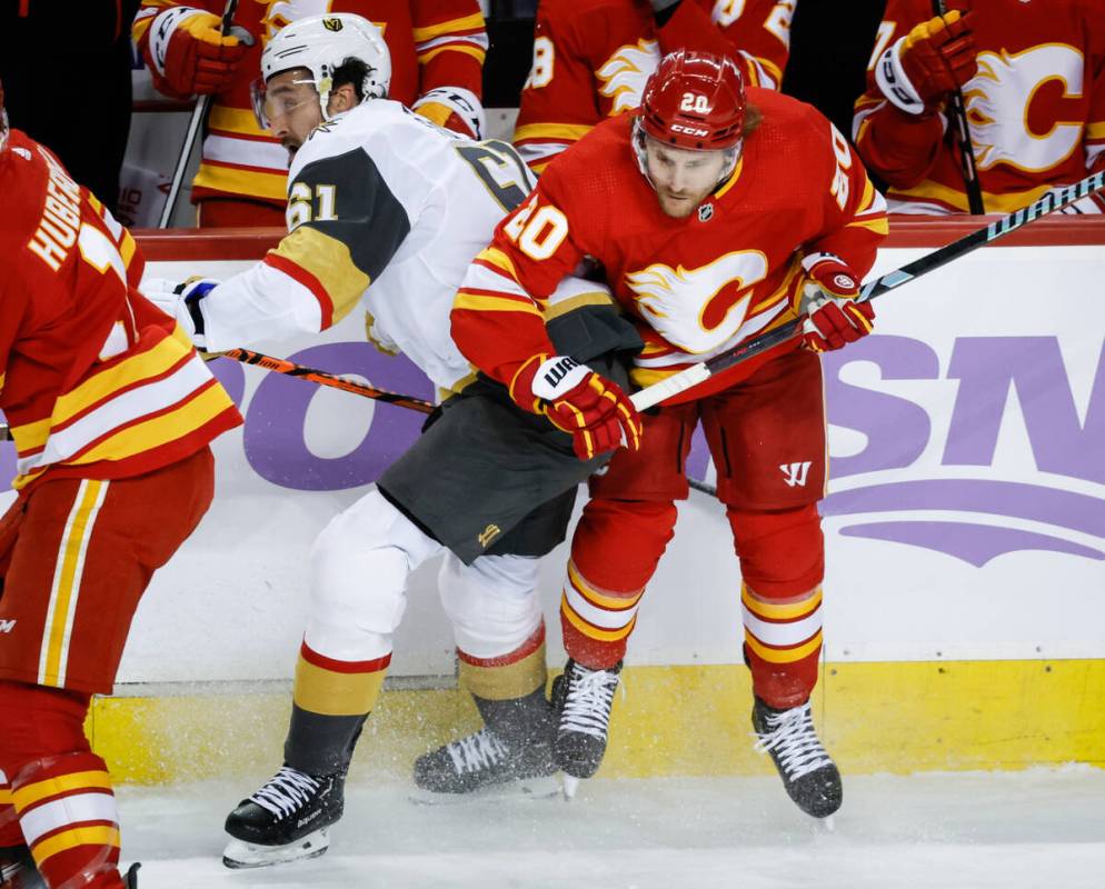 Vegas Golden Knights forward Mark Stone (61) checks Calgary Flames forward Blake Coleman (20) d ...